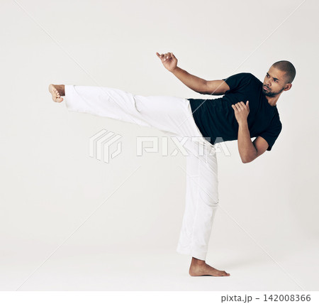 Martial arts, karate and man with training, fitness and wellness on a white studio background. Healthy person, fighter and model with practice and self defense with sports and striking with workout 142008366