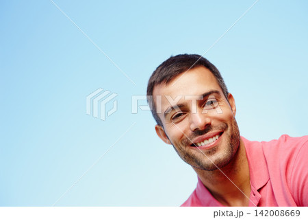 Man, portrait and smile by blue sky on holiday, peace and freedom on weekend trip. Happy male person, mockup space and tourist face for travel and relax in outdoor nature, getaway and summer vacation 142008669