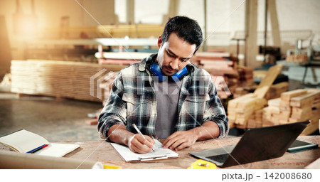 Man, carpenter and writing at workshop with clipboard, stock and pricing timber for production. Person, laptop and checklist at factory for carpentry, quotation and order for manufacturing furniture 142008680