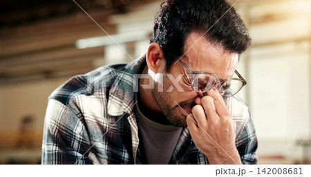 Man, carpenter and glasses with eye strain in workshop for wood production fail or delay. Frustrated, male person or carpentry mistake with stress for bad news, pressure or deadline in warehouse Man, carpenter and glasses with eye strain in workshop for wood production fail or delay. Frustrated, male person or carpentry mistake with stress for bad news, pressure or deadline in warehouse 142008681