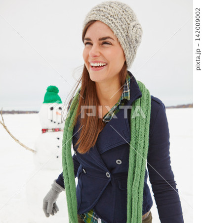 Woman, snowman and smile in nature on holiday with thinking, clothes and adventure in cold. Person, snow sculpture and memory with playful creativity in countryside at vacation resort in Switzerland Woman, snowman and smile in nature on holiday with thinking, clothes and adventure in cold. Person, snow sculpture and memory with playful creativity in countryside at vacation resort in Switzerland 142009002