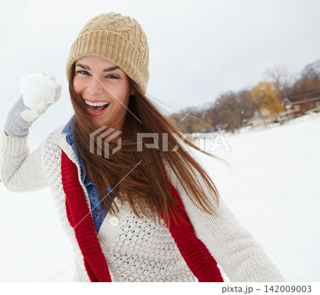 Portrait, snowball or happy girl in winter to play in beanie or jersey in Sweden on holiday vacation. Female person, throw or face of woman on outdoor trip for travel, adventure or wellness in nature 142009003