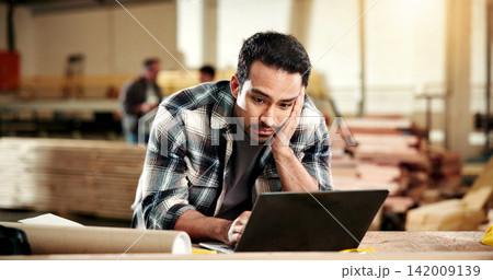 Carpenter, stress and man with laptop in workshop, furniture production or delivery delay on website. Unhappy, woodworker and person with tech, reading and anxiety with financial pressure in factory Carpenter, stress and man with laptop in workshop, furniture production or delivery delay on website. Unhappy, woodworker and person with tech, reading and anxiety with financial pressure in factory 142009139