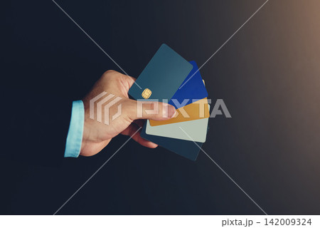 Businessman, hand and credit card in studio for wireless transaction, credit score and accounting. Financial advisor, payment and e commerce on dark background for payment authorisation and sales Businessman, hand and credit card in studio for wireless transaction, credit score and accounting. Financial advisor, payment and e commerce on dark background for payment authorisation and sales 142009324