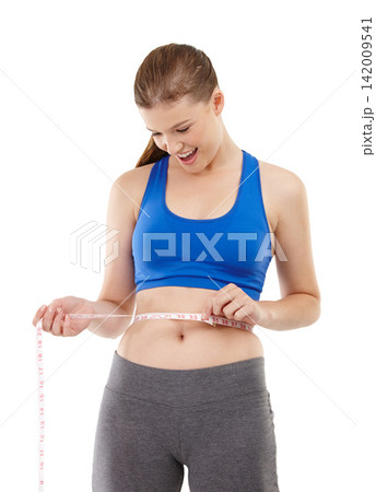 Goals of woman, surprise and measuring tape in studio for measurement, happy and excited for results of diet. Female person, body and care for calories target, weight loss and white background 142009541