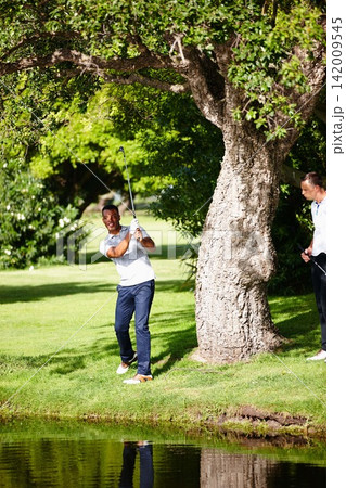 Men, golf course and pond for sports, game challenge and exercise for hobby in summer trip outdoor. Golfers or friends and play for recreation on field for training, activity and swing for vacation Men, golf course and pond for sports, game challenge and exercise for hobby in summer trip outdoor. Golfers or friends and play for recreation on field for training, activity and swing for vacation 142009545