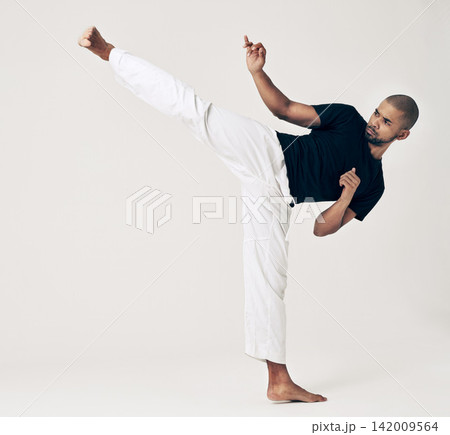 Martial arts, karate and man with training, wellness and self defense on white studio background. Healthy person, fighter and model with practice and conflict with sports and competition with workout Martial arts, karate and man with training, wellness and self defense on white studio background. Healthy person, fighter and model with practice and conflict with sports and competition with workout 142009564