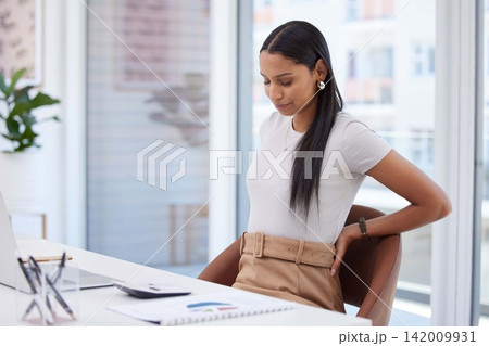 Woman, burnout and stress with back pain in office frustrated for injury, fatigue and muscle ache or posture. Female person, laptop and spine problem at work for medical, emergency or health 142009931