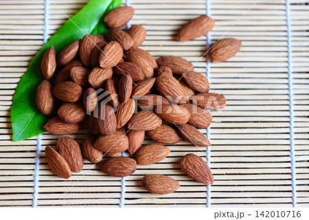 Almonds nuts on wooden with leaf almonds top view background, Roasted almond for snack 142010716