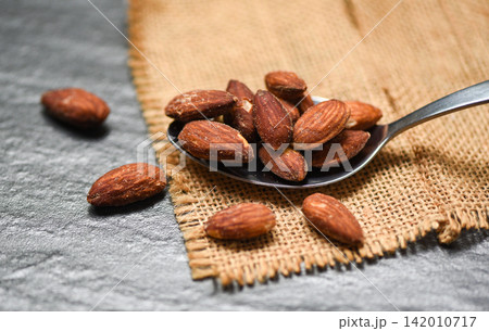 Almonds roasted in a spoon on sack almonds nuts baked salt 142010717