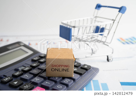 Online shopping, Shopping cart box on calculator, import export, finance commerce. Online shopping, Shopping cart box on calculator, import export, finance commerce. 142012479