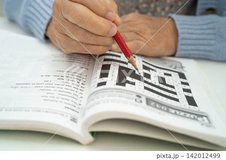 Bangkok, Thailand - January 19, 2025 elderly woman playing puzzle game. 142012499