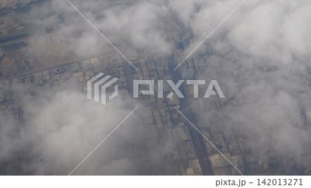 Aerial view of urban landscape with clouds and industrial structures 142013271