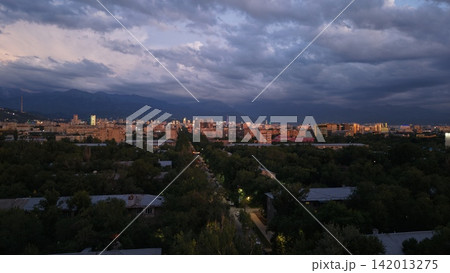 Panoramic view of Almaty city skyline with mountains and dramatic clouds Panoramic view of Almaty city skyline with mountains and dramatic clouds 142013275