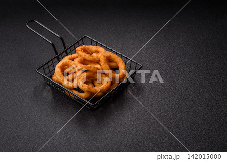 Deep fried breaded onion or squid rings, crispy fast food snacks. Fried onion or squid rings Deep fried breaded onion or squid rings, crispy fast food snacks. Fried onion or squid rings 142015000