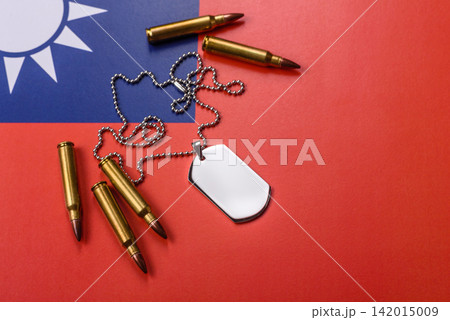 A dog tag on the taiwanese flag, serving as a conceptual backdrop representing defense A dog tag on the taiwanese flag, serving as a conceptual backdrop representing defense 142015009