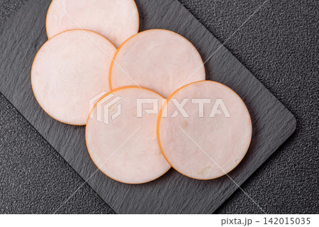 Slices of boiled chicken or pork sausage as an ingredient for home cooking. Sliced boiled sausage Slices of boiled chicken or pork sausage as an ingredient for home cooking. Sliced boiled sausage 142015035