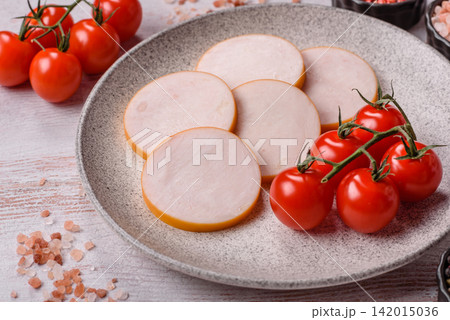 Slices of boiled chicken or pork sausage as an ingredient for home cooking. Sliced boiled sausage Slices of boiled chicken or pork sausage as an ingredient for home cooking. Sliced boiled sausage 142015036