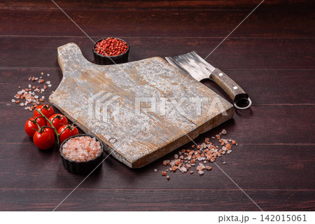 A square wooden cutting board for home food preparation. A wooden cutting board A square wooden cutting board for home food preparation. A wooden cutting board 142015061