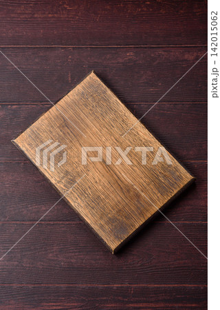 A square wooden cutting board for home food preparation. A wooden cutting board A square wooden cutting board for home food preparation. A wooden cutting board 142015062