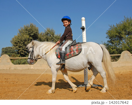 riding child and pony riding child and pony 142017642