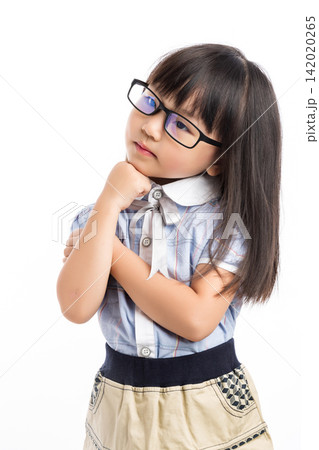 Pensive little girl looking away and thinking with her hand on chin against white background. Pensive little girl looking away and thinking with her hand on chin against white background. 142020265