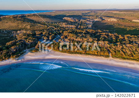 Aerial view of Diamond Head Campground beside the sandy beach and Pacific Ocean, surrounded by native coastal vegetation and natural landscape in Crowdy Bay National Park on the Mid North Coast Aerial view of Diamond Head Campground beside the sandy beach and Pacific Ocean, surrounded by native coastal vegetation and natural landscape in Crowdy Bay National Park on the Mid North Coast 142022671