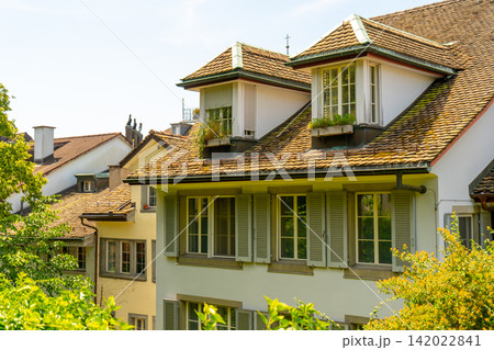 European Houses with Tiled Roofs, Dormer Windows and Lush Green. Old architecture 142022841