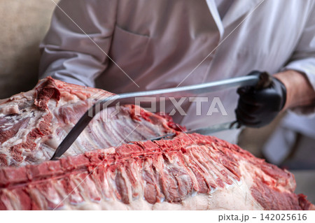 Preparing and cutting meat on the butcher's block Preparing and cutting meat on the butcher's block 142025616
