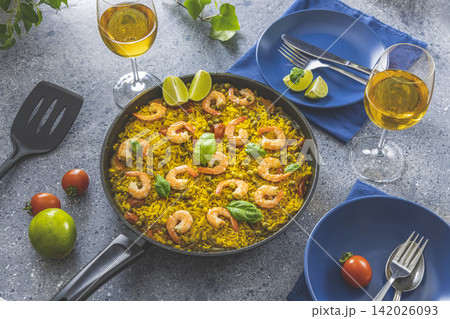 Traditional spanish seafood paella in the fry pan. Dinner served with wine. Traditional spanish seafood paella in the fry pan. Dinner served with wine. 142026093