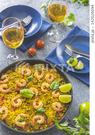 Traditional spanish seafood paella in the fry pan. Dinner served with wine. Traditional spanish seafood paella in the fry pan. Dinner served with wine. 142026094