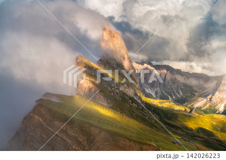 Seceda mountain peak with dramatic fog and clouds at sunset Seceda mountain peak with dramatic fog and clouds at sunset 142026223