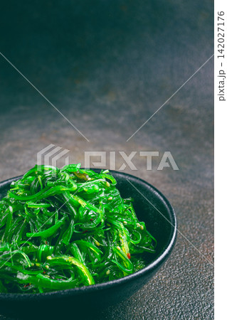 Chuka salad, made from fresh seaweed, with sesame dressing, served in a black bowl, Chuka salad, made from fresh seaweed, with sesame dressing, served in a black bowl, 142027176
