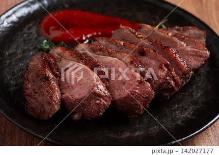 roast duck breast, sliced on a plate, with red sauce, homemade, no people, roast duck breast, sliced on a plate, with red sauce, homemade, no people, 142027177