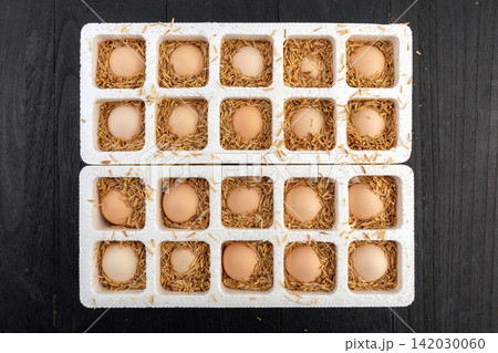 fresh farm eggs in woven basket with broken egg yolk fresh farm eggs in woven basket with broken egg yolk 142030060