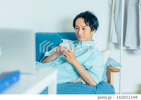 スマホを見る若い男性 スマホを見る若い男性 142031149