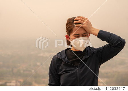Asian woman having headache becaused of by Bad air pollution (PM2.5). Asian woman having headache becaused of by Bad air pollution (PM2.5). 142032447