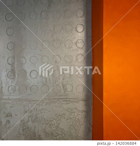 Decorative grey plaster cement material with orange border on wall in interior Decorative grey plaster cement material with orange border on wall in interior 142036884