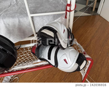 a pair of hockey gloves and a pair of hockey skates a pair of hockey gloves and a pair of hockey skates 142036916