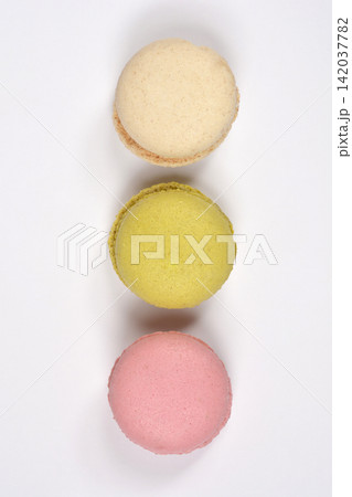 Top view of three colorful macarons in a vertical row 142037782
