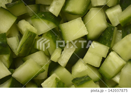 Chopped fresh green cucumber cubes close up 142037875