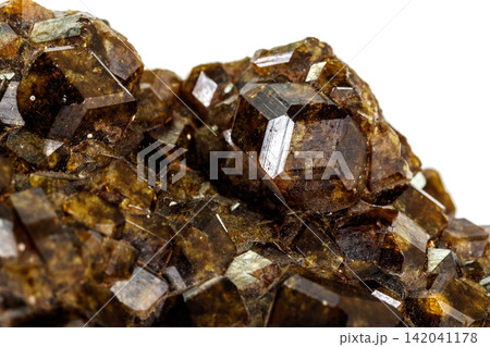 Macro stone Grossular mineral in rock on a white background Macro stone Grossular mineral in rock on a white background 142041178