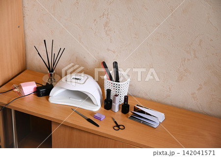 Nail care tools and items ready for use in a beauty salon setting during the day 142041571