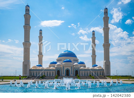 Nursultan mosque with four tall minarets and blue dome against blue sky in Astana Kazakhstan, Islamic landmark concept Nursultan mosque with four tall minarets and blue dome against blue sky in Astana Kazakhstan, Islamic landmark concept 142042380