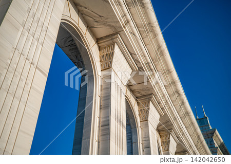arches of a colonnade against of blue sky background 142042650