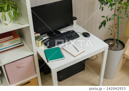 Orderly workspace setup. Organized desk, work from home concept. Remote office station with laptop display, keyboard, paperwork. Work place for distance working. Tidy table with monitor and printer 142042953