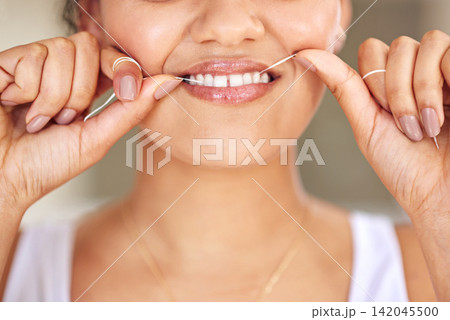 Happy, dental floss and mouth of woman with cleaning teeth for morning routine with health. Smile, dentistry and closeup of person with oral care product for hygiene treatment to prevent cavity. Happy, dental floss and mouth of woman with cleaning teeth for morning routine with health. Smile, dentistry and closeup of person with oral care product for hygiene treatment to prevent cavity. 142045500