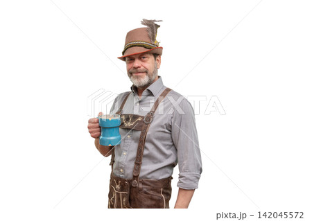 Smiling middle aged man in Bavarian costume holding blue tankard isolated Smiling middle aged man in Bavarian costume holding blue tankard isolated 142045572