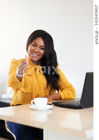 Thumbs up, laptop and portrait of black woman in office with approval or agreement for online b2b deal. Smile, coffee and African professional female property manager with computer in workplace. 142045607