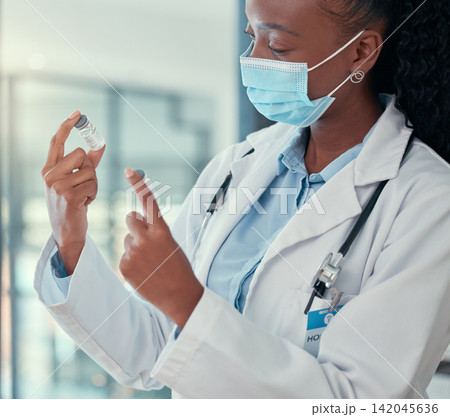 Hospital, healthcare and doctor with vaccine, medicine and cure for medical service, wellness and disease. Professional, clinic and black woman in mask with medication, liquid and injection treatment Hospital, healthcare and doctor with vaccine, medicine and cure for medical service, wellness and disease. Professional, clinic and black woman in mask with medication, liquid and injection treatment 142045636